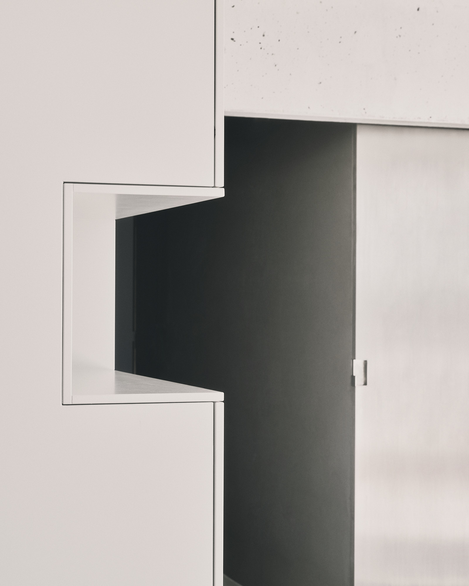 L48 detail — white joinery corner meeting exposed concrete column
